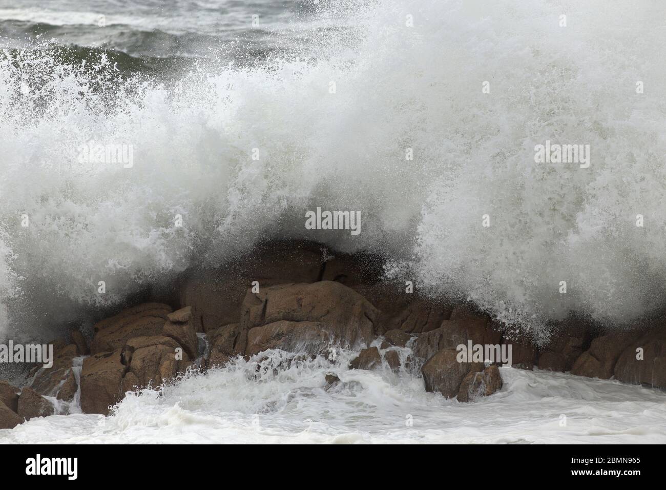 Detailed big breaking wave splash against rocks Stock Photo - Alamy
