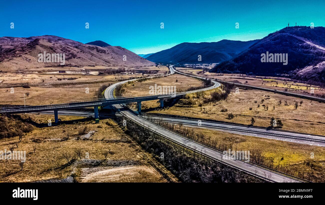 Aerial view of a highway intersection in a rural and mountainous area ...