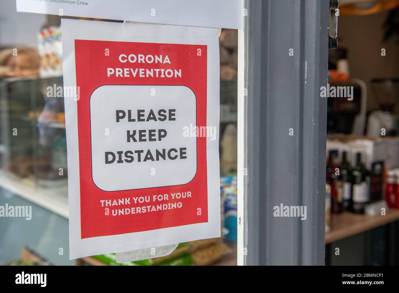 A sign in a shop requesting that social distancing is observed during lockdown for coronavirus in 2020 Stock Photo