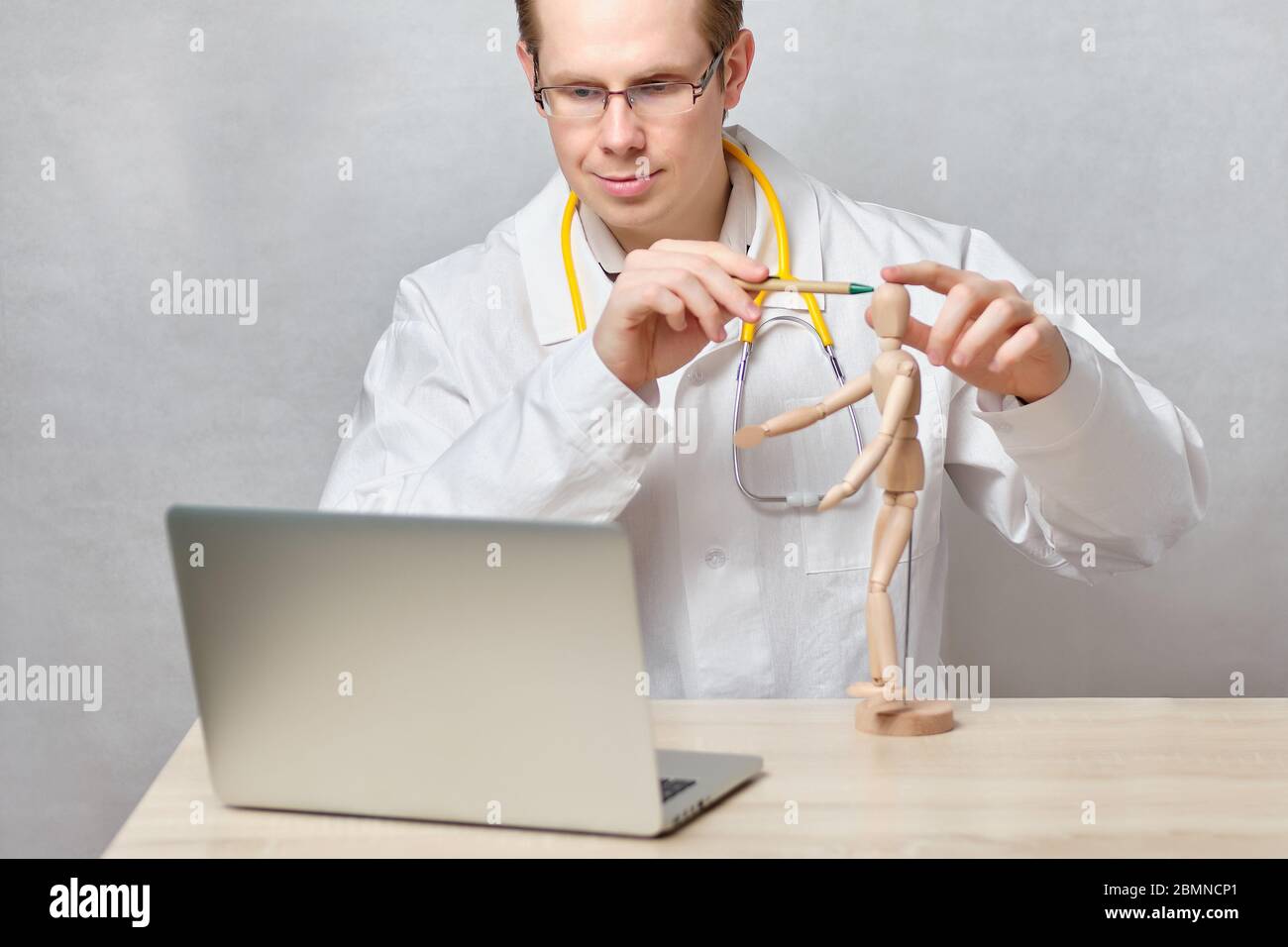 The doctor conducts an online lesson on the treatment of headaches through a laptop. Close up. Stock Photo