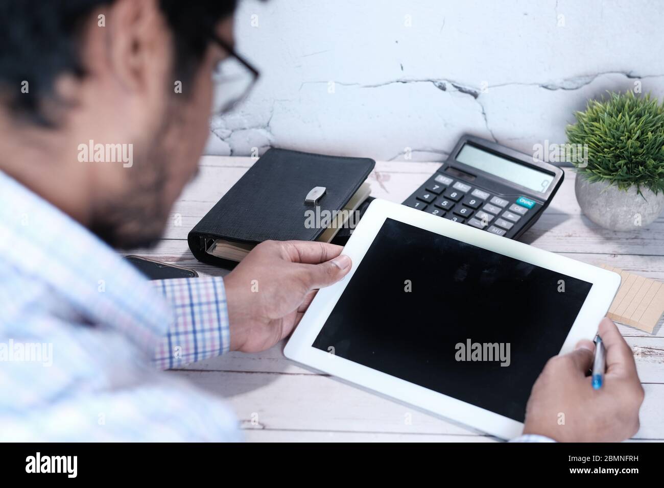 young man working on digital tablet with empty screen Stock Photo