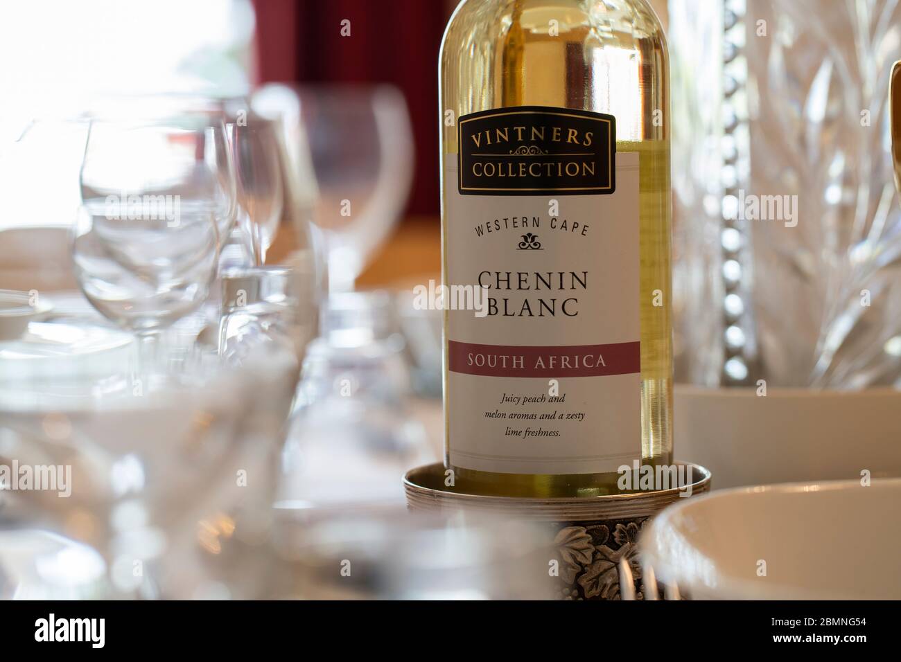 A bottle of white wine on a dressed table Stock Photo