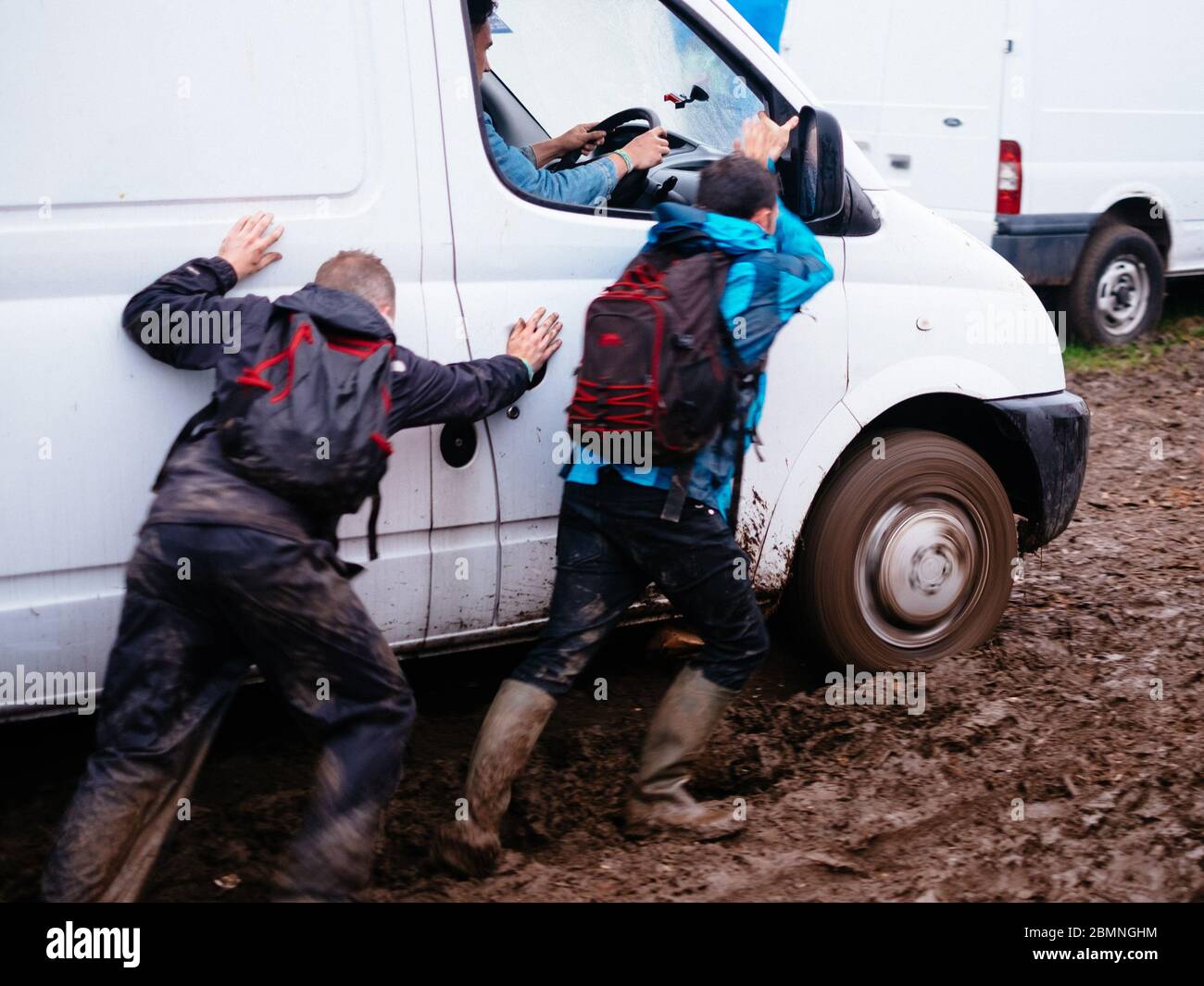 People trying to get a stuck van out of the mud   Glastonbury Festival 2016 – Picture date Sunday 26 June, 2016 (Pilton, Somerset)    Photo copyright, Stock Photo