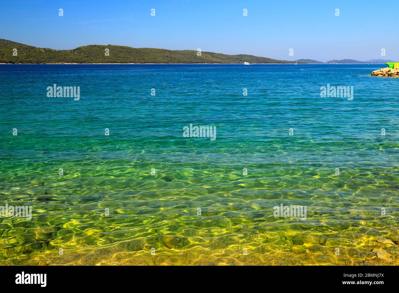 Sea background. Transparent, clear water on clean summer Blue flag beach. Rocks and beautiful sea. Croatian summer vacation, travel and tourism, text Stock Photo