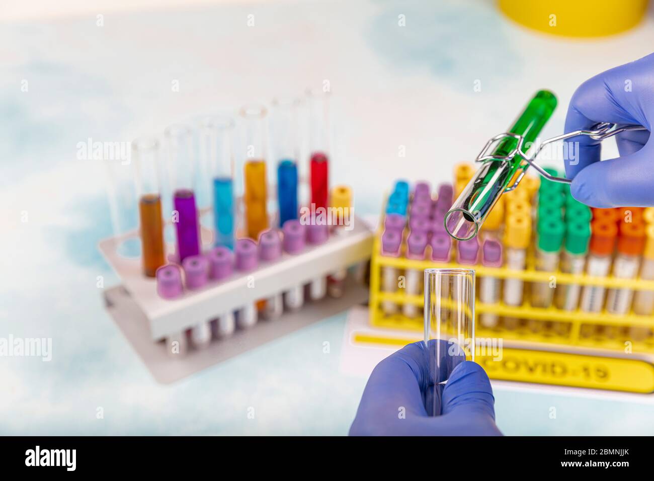 Lab worker preparing test blood for detection of antibodies and ...