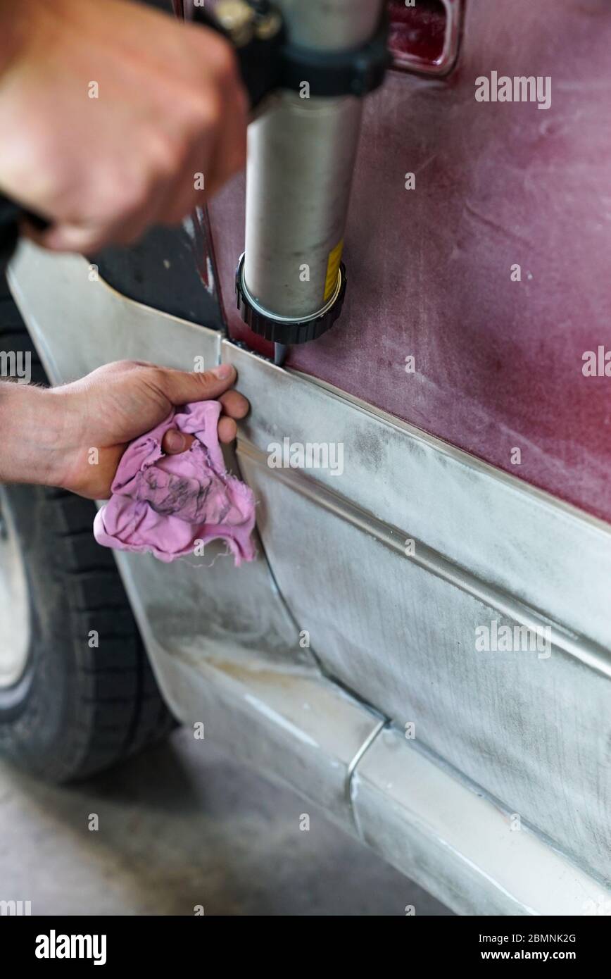 Auto body repair series: Working on putty Stock Photo by ©kunksy