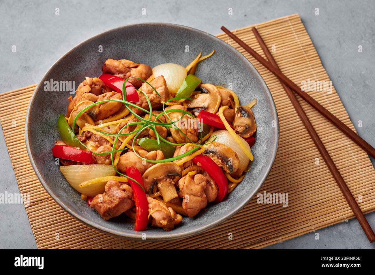 Thai Ginger Chicken or Gai Pad King in gray matte bowl on concrete  backdrop. Gai Pad King is Thailand cuisine dish with chicken meat, ginger  strips, o Stock Photo - Alamy