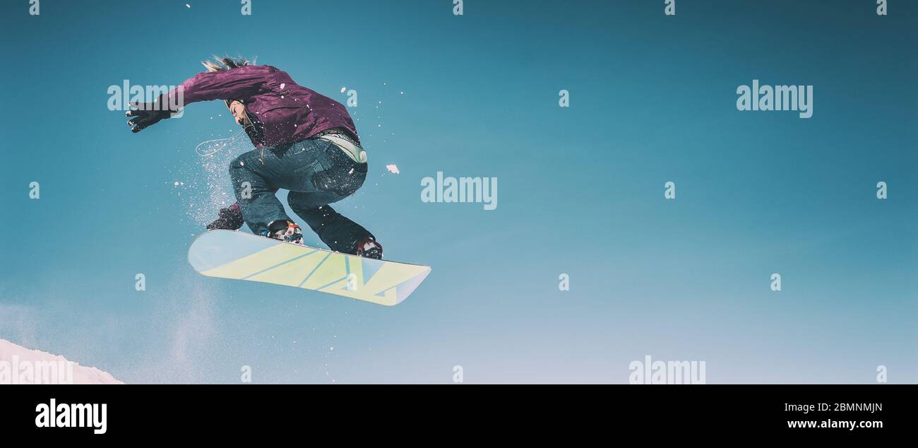 Freerider snowboarder doing speed trick air jump with his snowboard. Winter mountain freeride Stock Photo