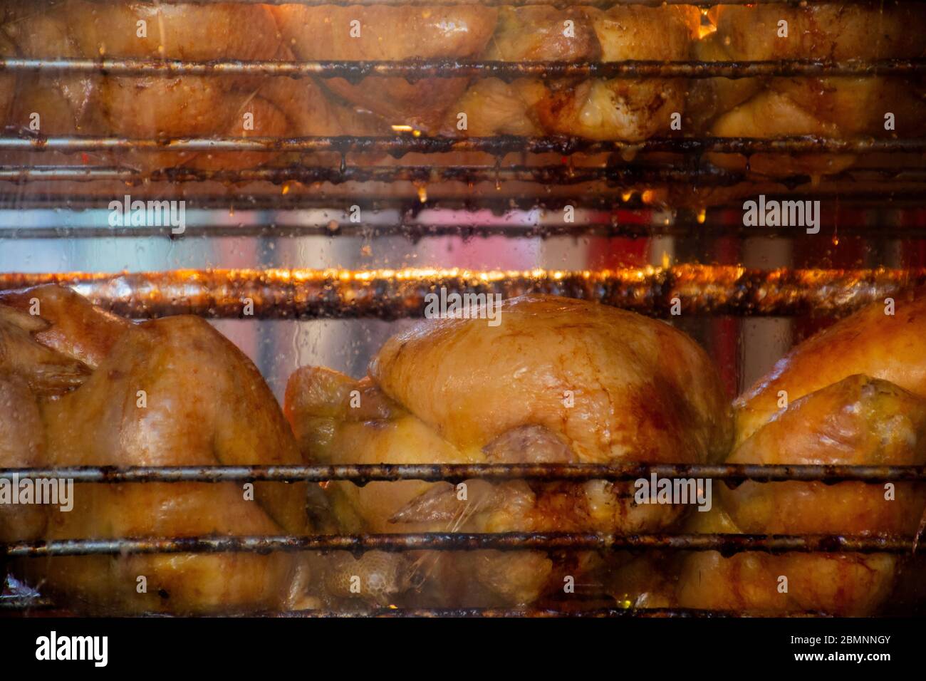 Greasy unhealthy chicken roasting in the oven Stock Photo Alamy
