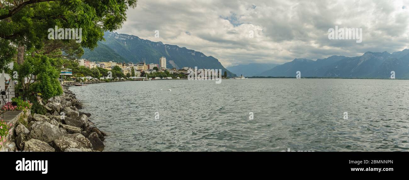 Wde angle Panorama. View on swiss promenade, alpine riviera and Lake Geneva landscape in Montreux city in SWITZERLAND. Stock Photo