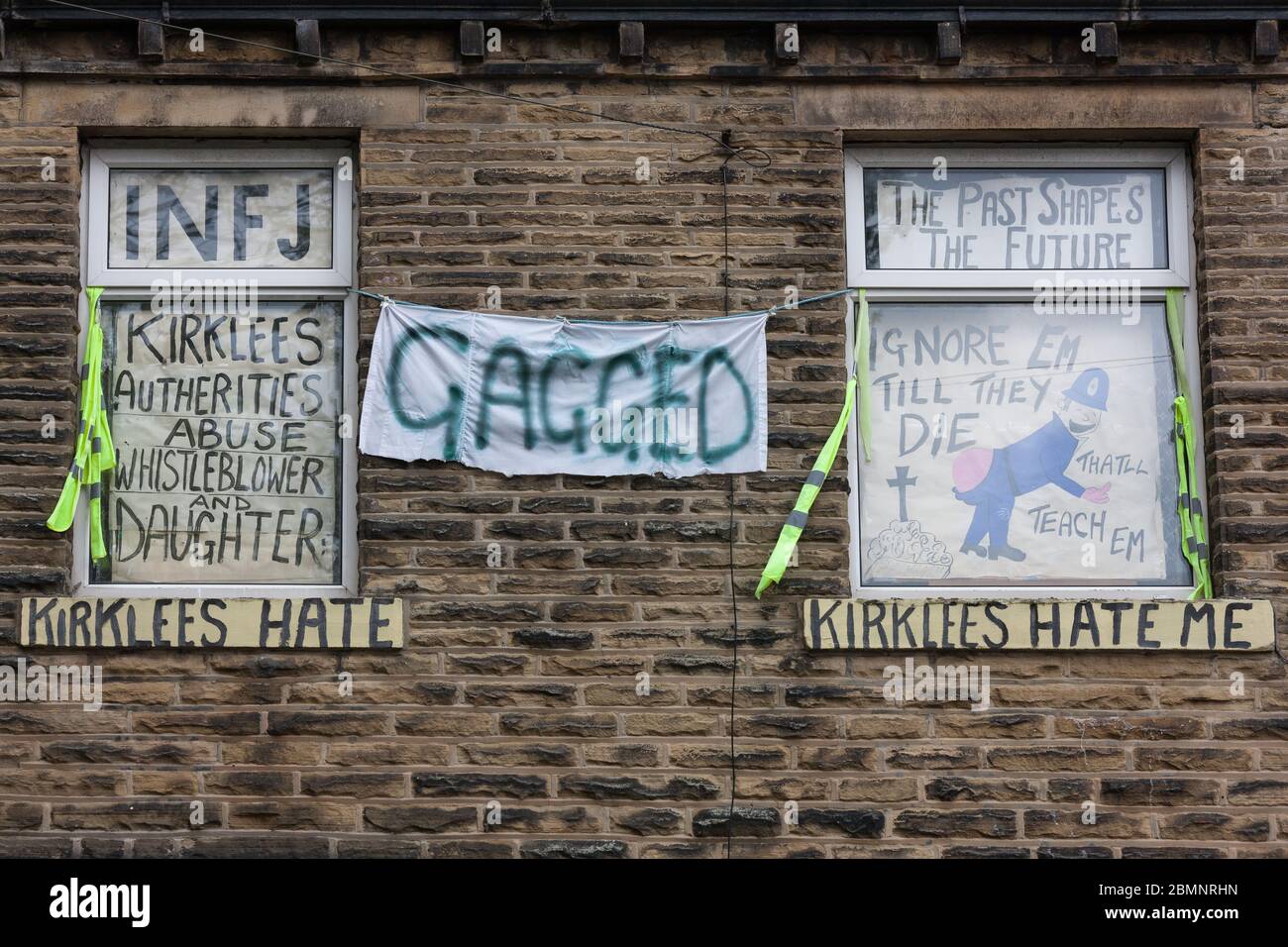 Meltham, UK - May 5 2020: A house in West Yorkshire covered with writing and signs protesting against Kirklees Council. Stock Photo