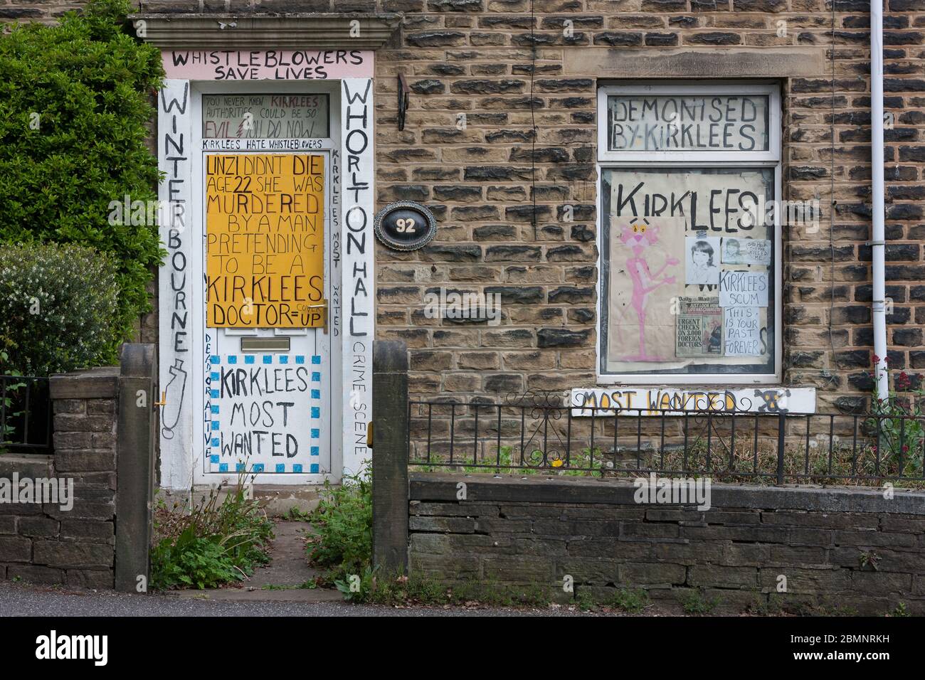 Meltham, UK - May 5 2020: A house in Meltham covered with writing and signs protesting against Kirklees Council, including references to NHS funded ho Stock Photo