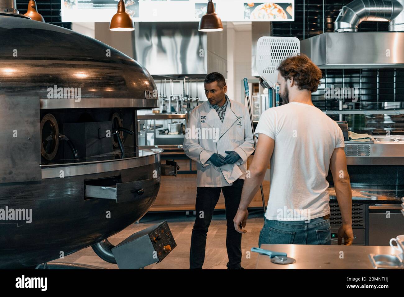 Wroclaw, Poland, December 20 2019.Opening of restaurant in Shell station placed in Katy Wroclawskie. Kitchen chef turns on Marana Forni Gea pizza oven Stock Photo