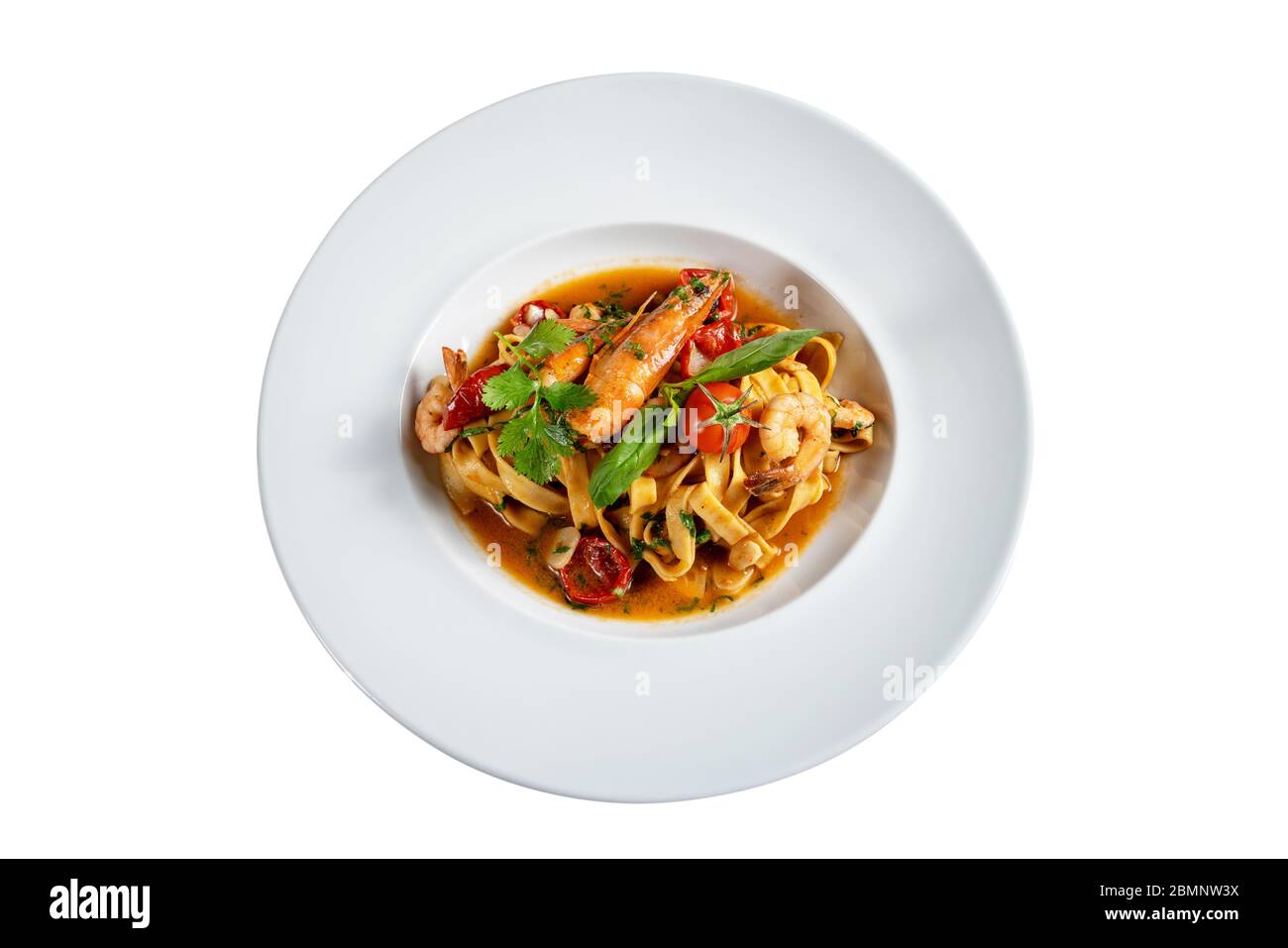 Italian pasta dish with shrimp stewed in sauce. On white background. Stock Photo