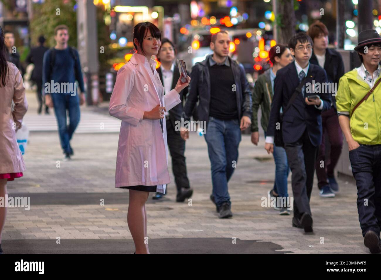 Tokyo / Japan - April 20, 2018: Young girl calling on passerby to visit the Maid Cafe in Akihabara district of Tokyo, Japan Stock Photo