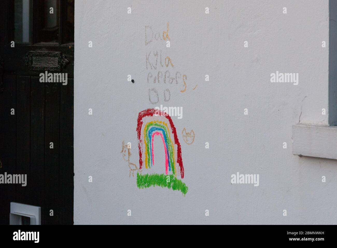 Huddersfield, UK - May 4 2020: A child's drawing of a rainbow in crayon on the side of a house in West Yorkshire. Stock Photo
