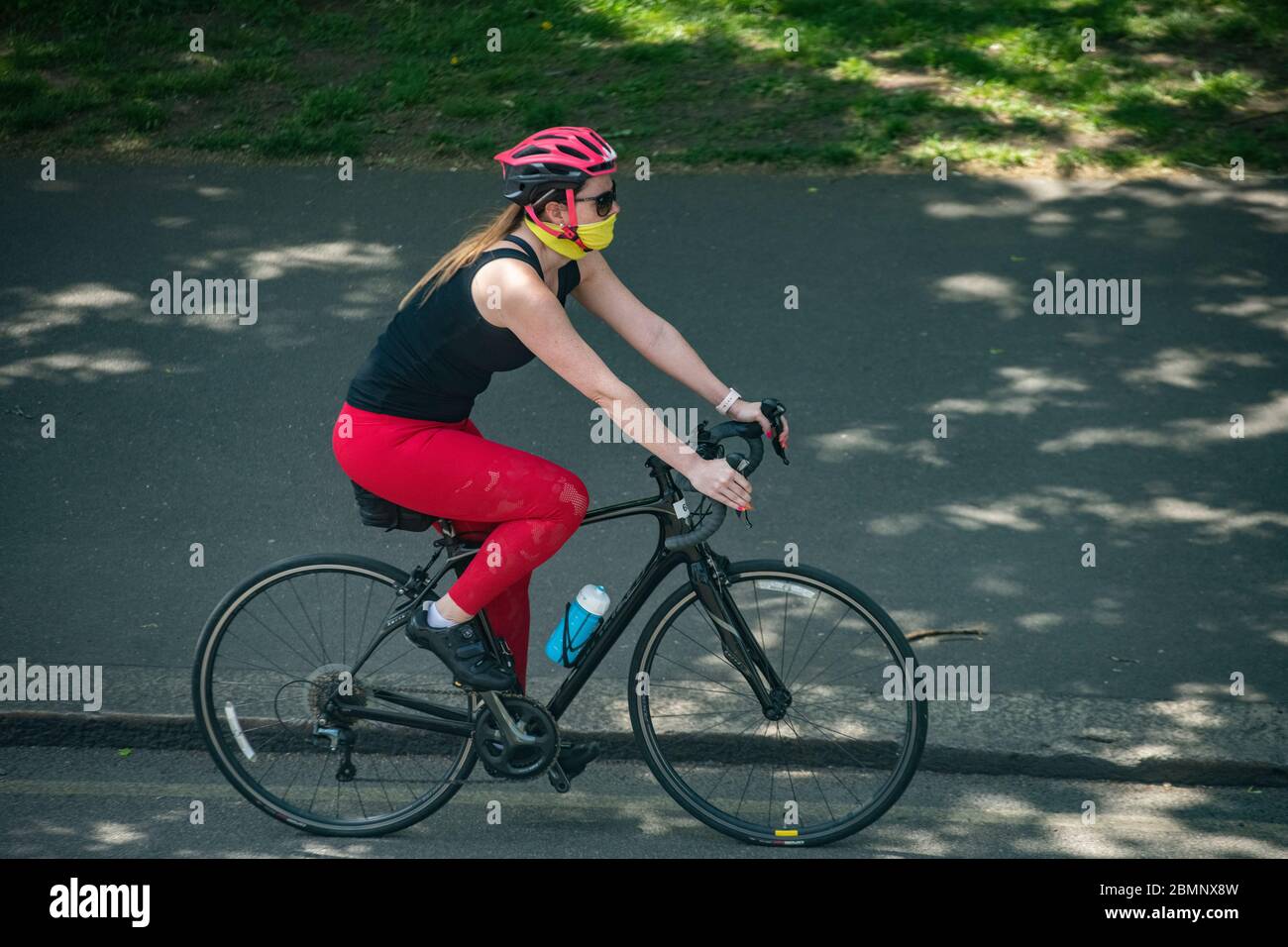 Riding a bike with a face mask during the coronavirus pandemic of 2020 Stock Photo