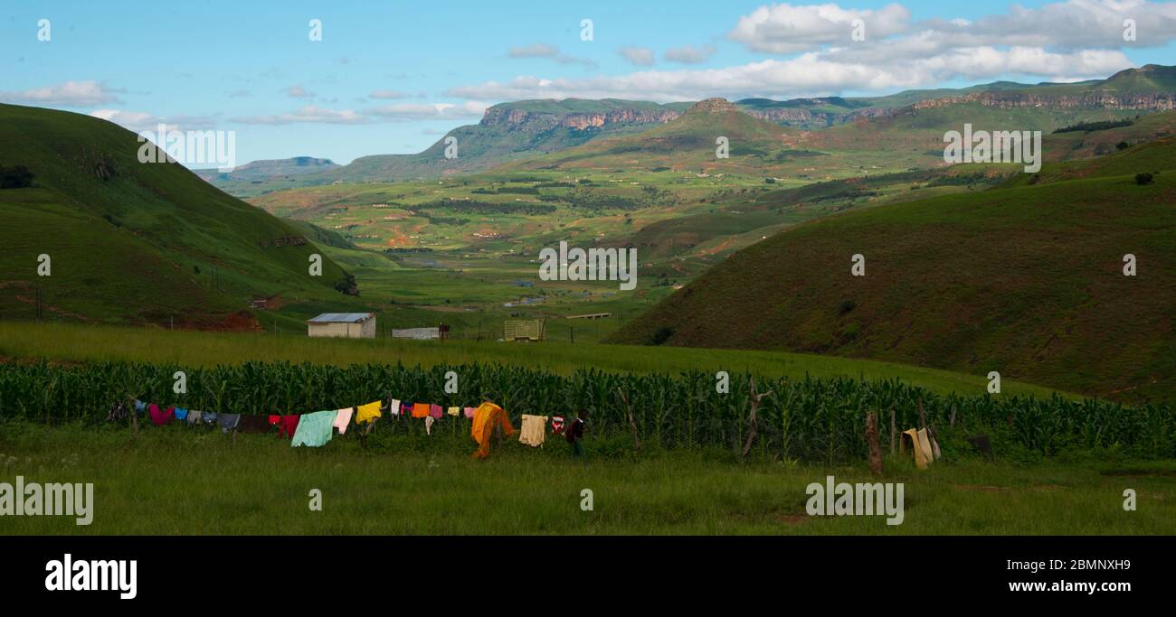 rural homestead with colorful clothesline in drakensberg mountains, kwazulu natal, south africa Stock Photo
