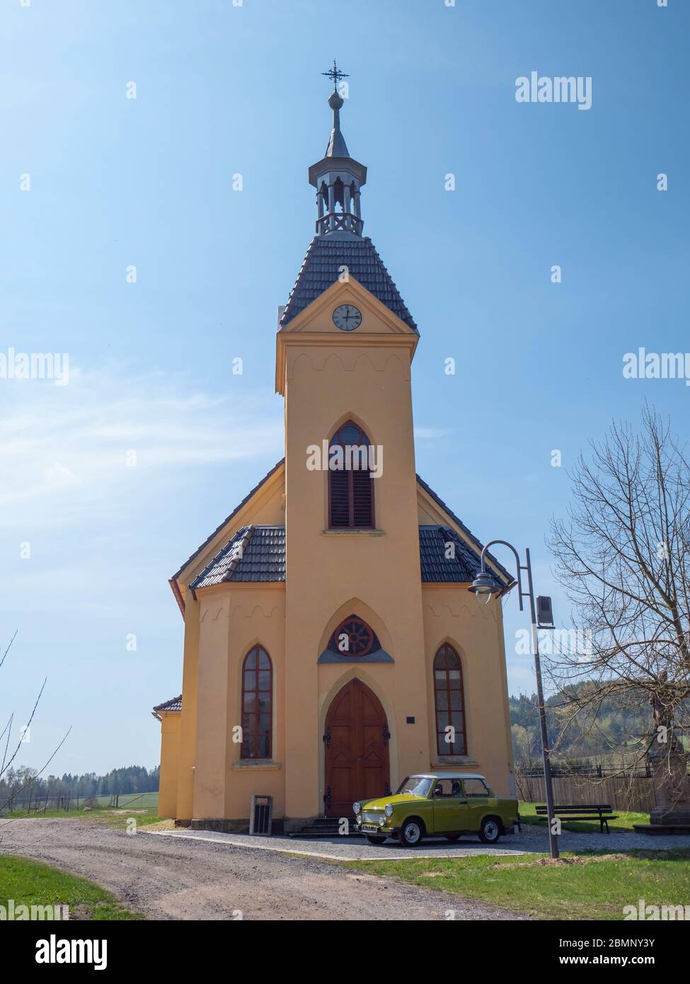 Hermanice v Podjestedi, Czech Republic , 17th of April 2020. Church of St. Anthony with Trabant sedan car, produced in East Germany. Stock Photo