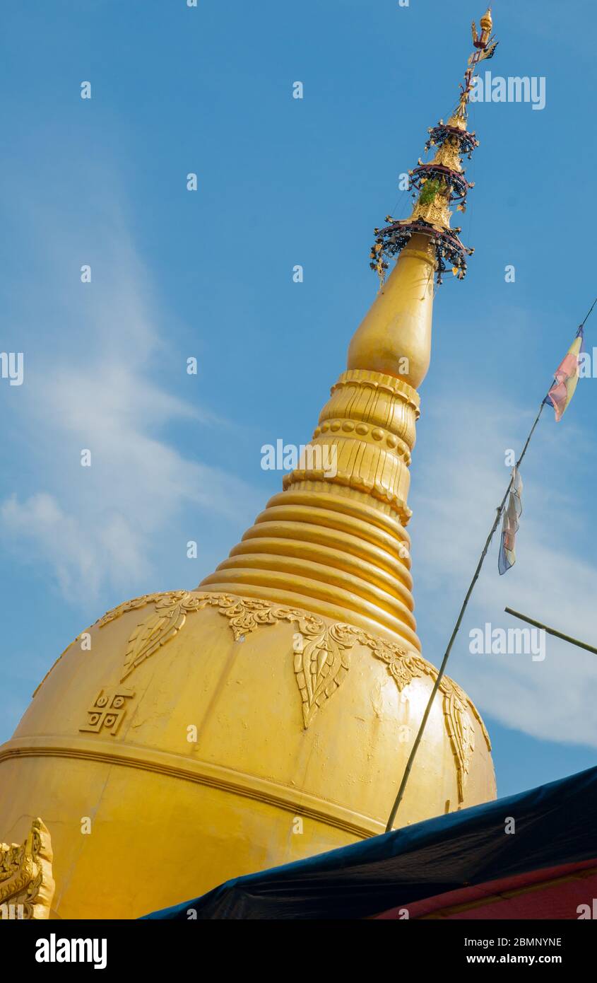 Myanmar travel  images golden Buddhist temple spire rising diagonaly into sky Stock Photo