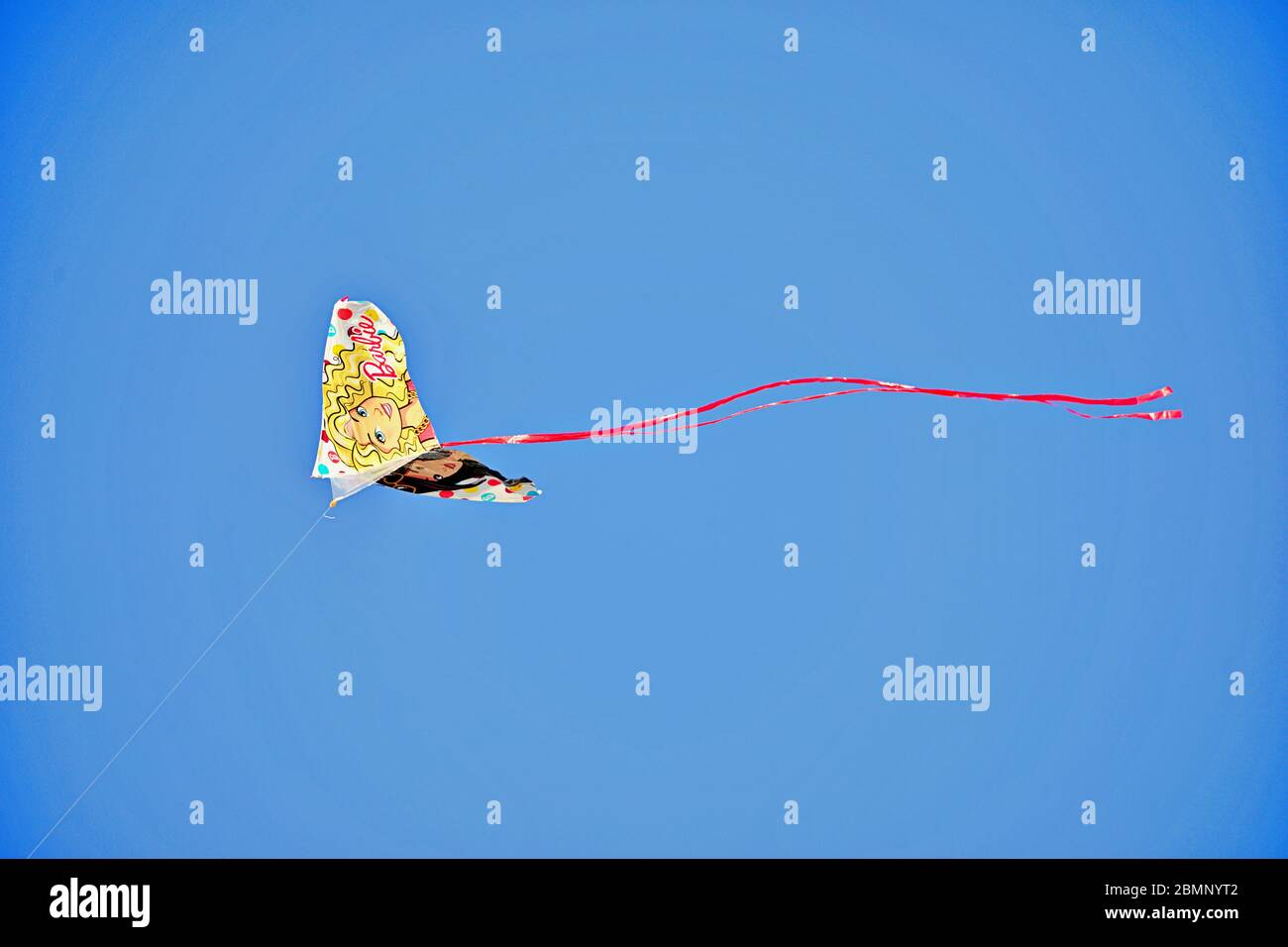 kite flying in blue sky Stock Photo
