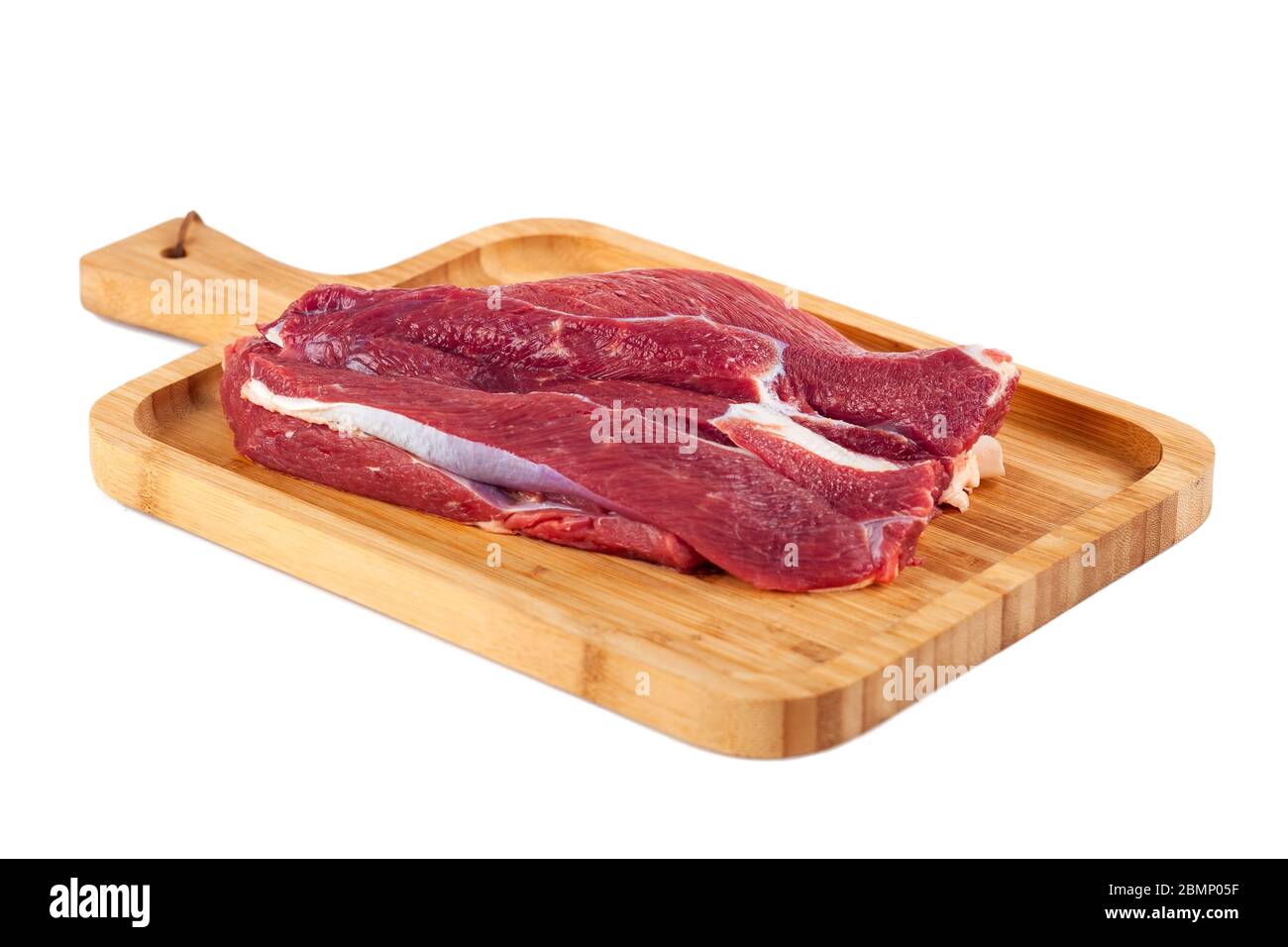 Raw meat on wooden board isolated on white background Stock Photo - Alamy