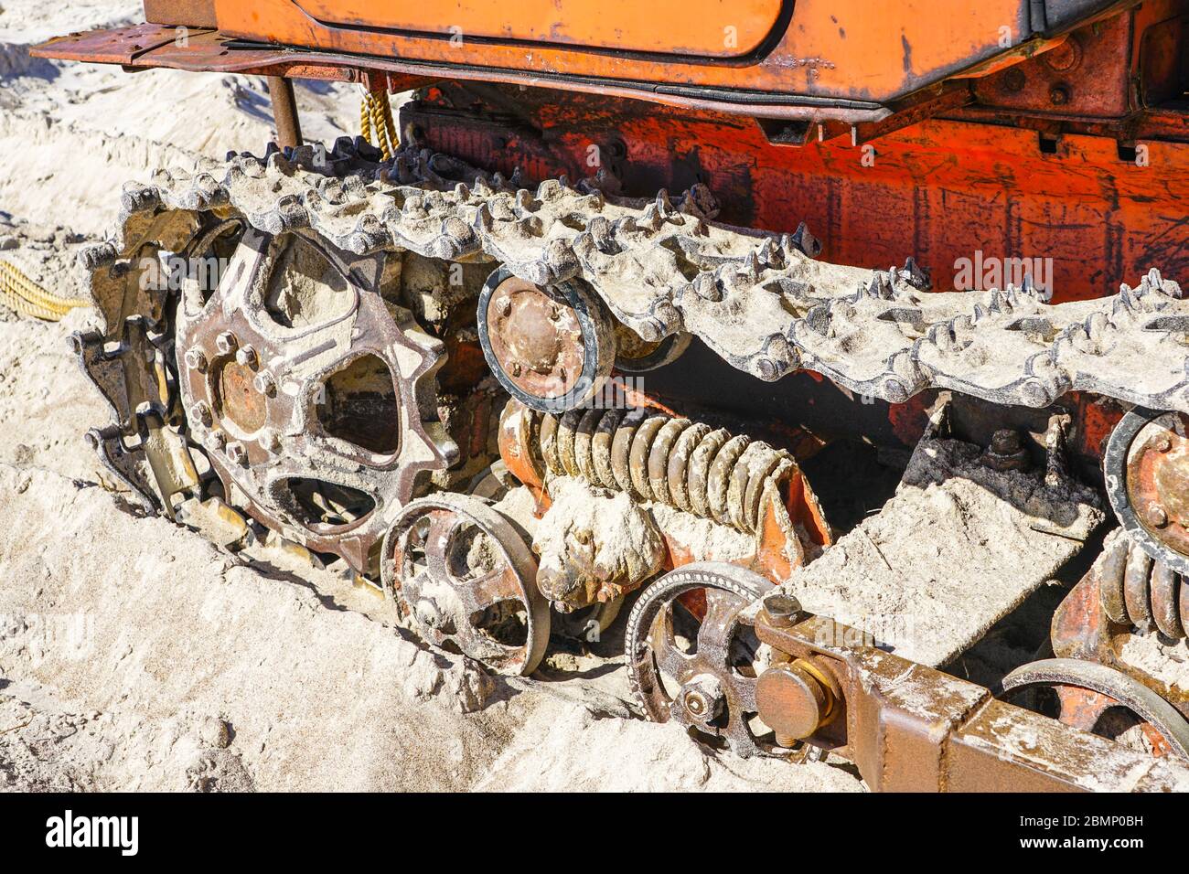 closeup tracked bulldozer drive mechanism that stands on the sandy ...