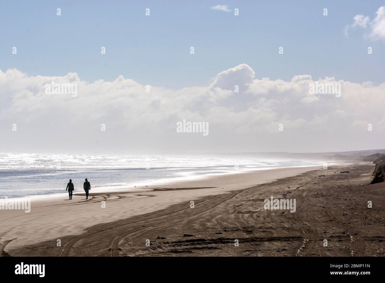 Couple in Ninety Mile Beach, New Zealand Stock Photo