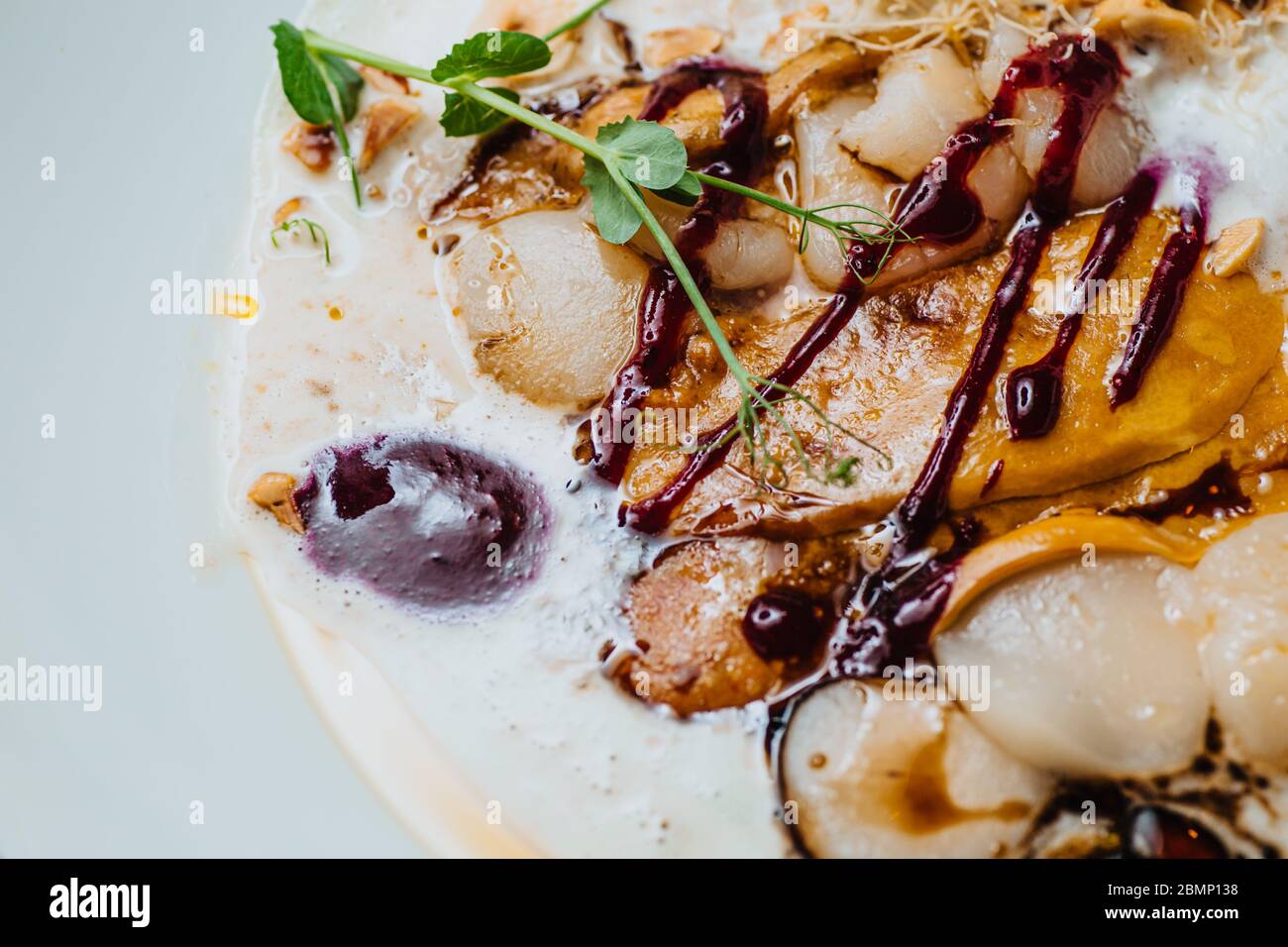 Scallop ceviche and foie gras with hazelnut, ready to serve. Stock Photo