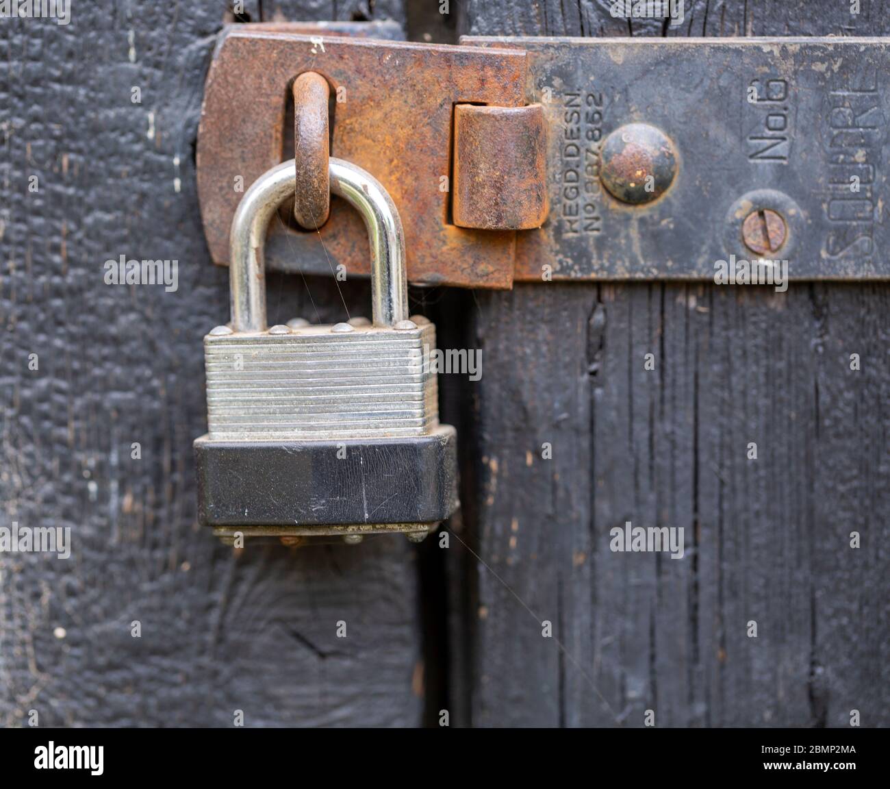 Macro close up of padlock securing door shut securely Stock Photo