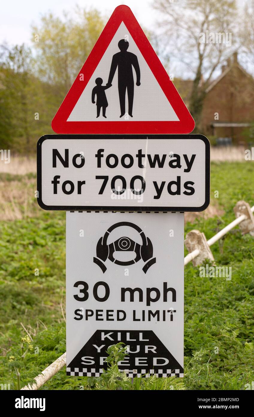 Road traffic signs warning of hazards no footway 30 mph speed limit, Shottisham, Suffolk, England, UK Stock Photo