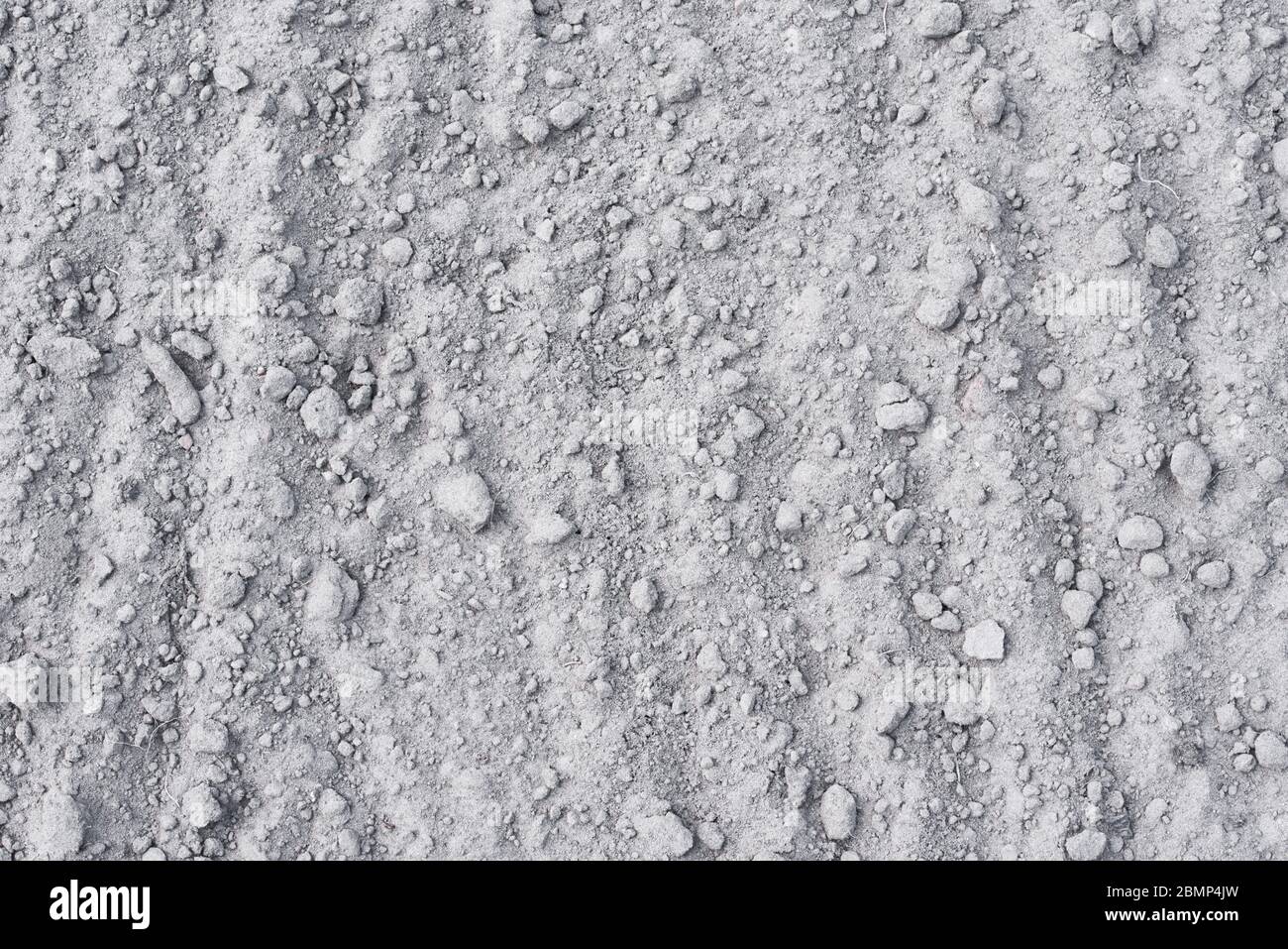 Dry soil background. Sand with stones as texture Stock Photo
