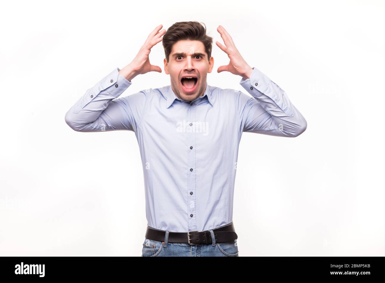 man screaming mouth open, hold head hand, wear casual blue shirt ...