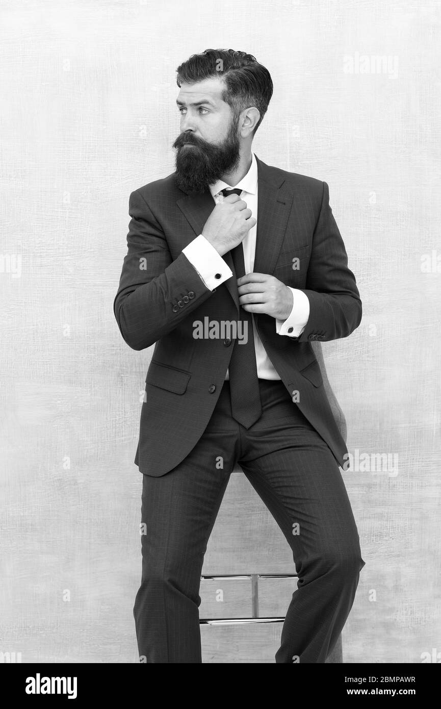 For formal occasion. Business fashion model fix tie. Bearded man with fashion look. Hipster in classy fashion style. Menswear store. Fashion and style. Streamlined design speak for itself. Stock Photo