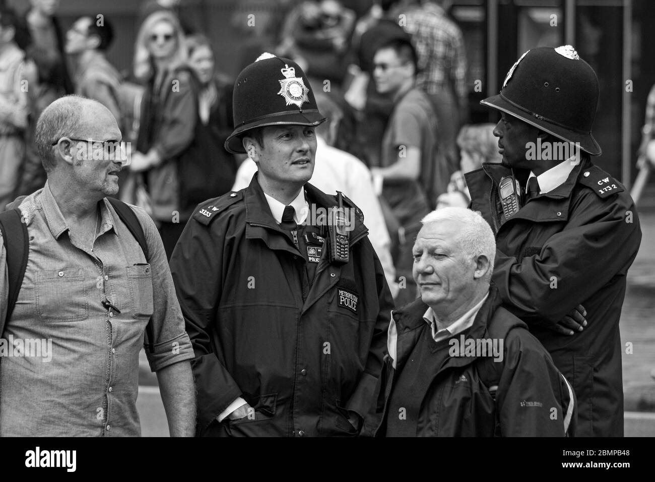 Two Metropolitan police officers with helmets on in London, England, United Kingdom, Great Britain Stock Photo