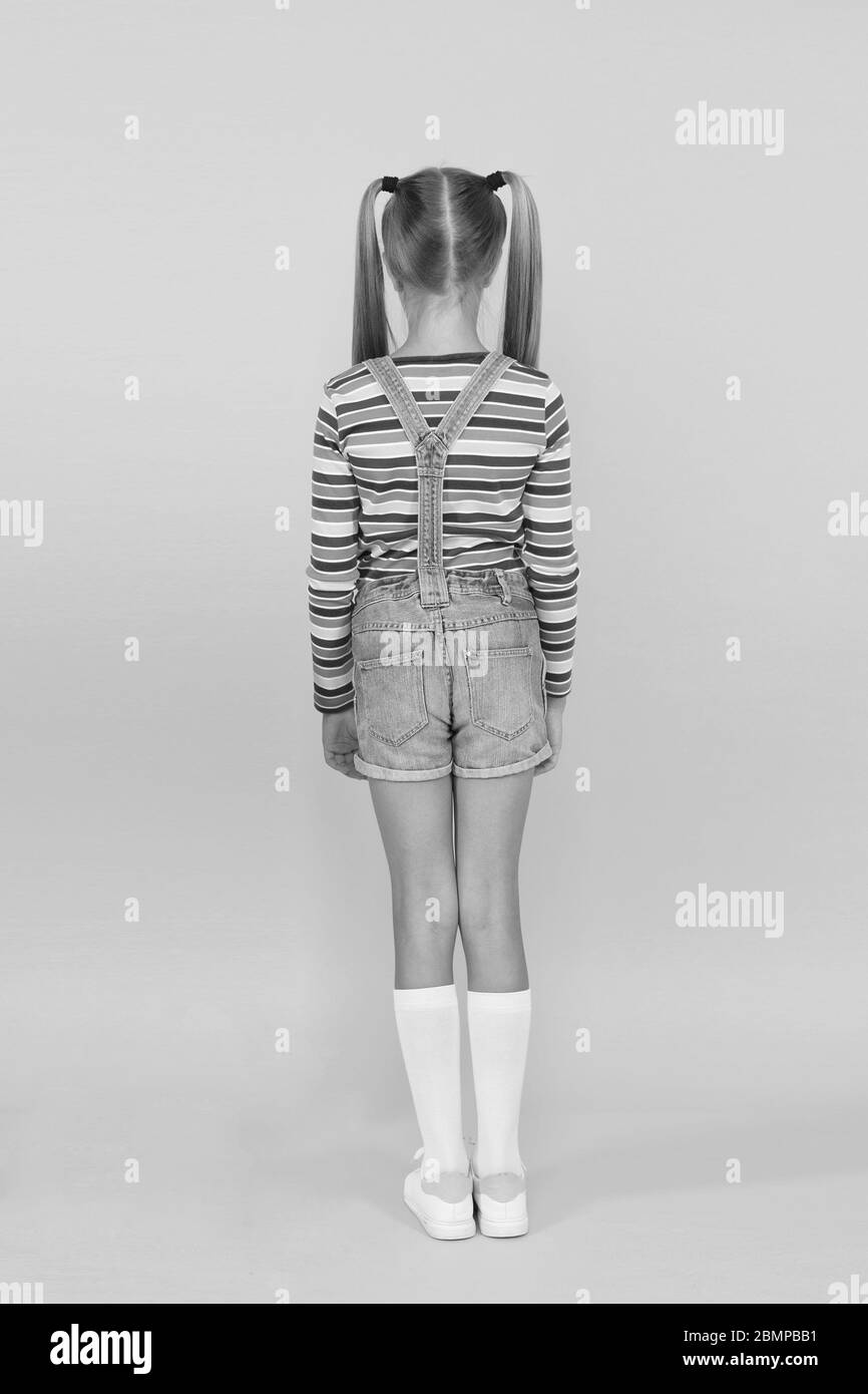 Girl cute child long hair double ponytails hairstyle rear view. Prevent