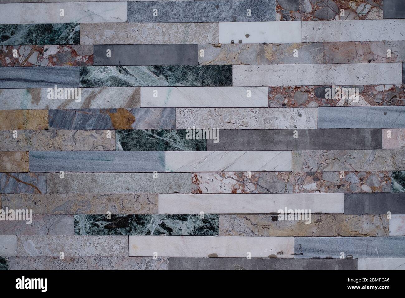Texture of the wall is lined with marble tiles. Stock Photo