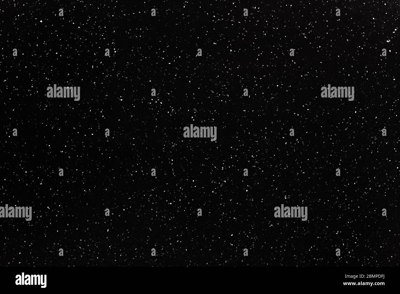 Black, plastic, grained cutting board with white dots. Stock Photo