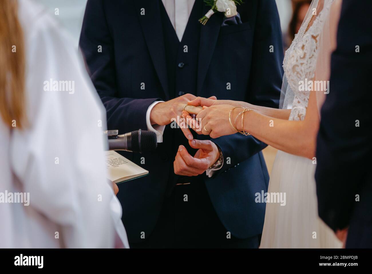 Bride and groom exchanging rings at their wedding Stock Photo