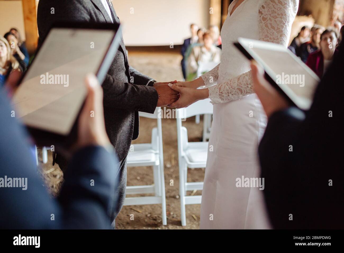 Bride and groom exchanging rings at their wedding Stock Photo