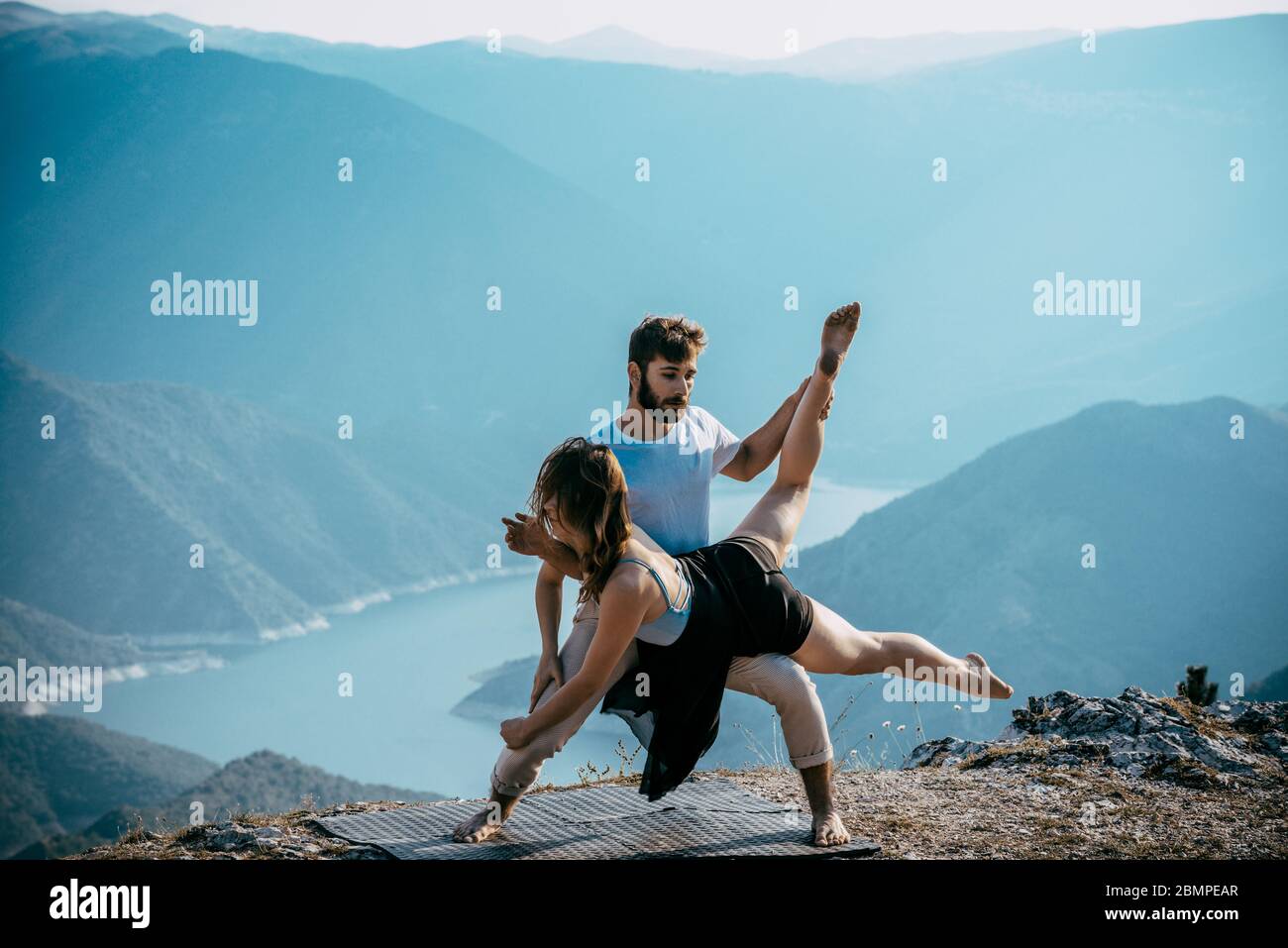 Young beautiful barefoot couple dancer practicing modern dance Stock Photo