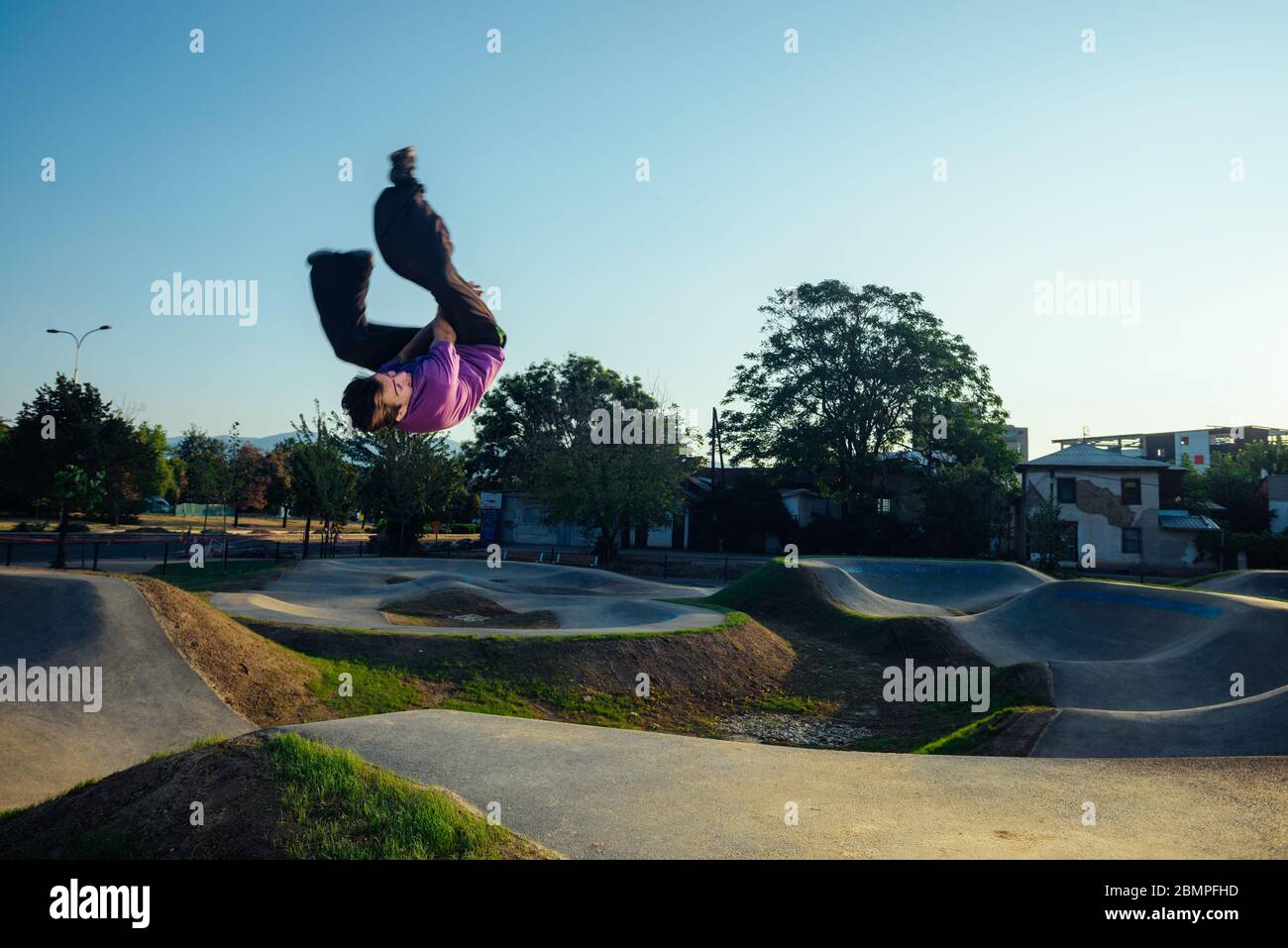 Athletic person during a side flip salto move in the air at the city skate  playground Stock Photo - Alamy