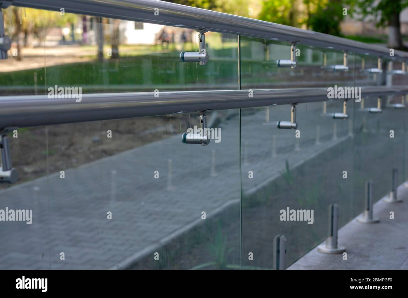 Dirty glass railing with chrome railing at the entrance to the building ...