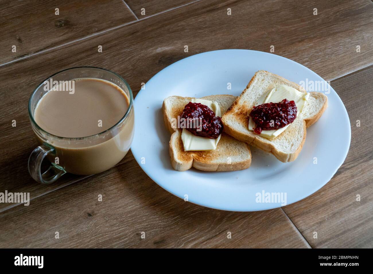 Cup Of Coffe With Milk And Two Slices Of Toasted Sandwich Bread With Butter And Raspberry Breakfast With Coffee Side View Free Space For Text Stock Photo Alamy