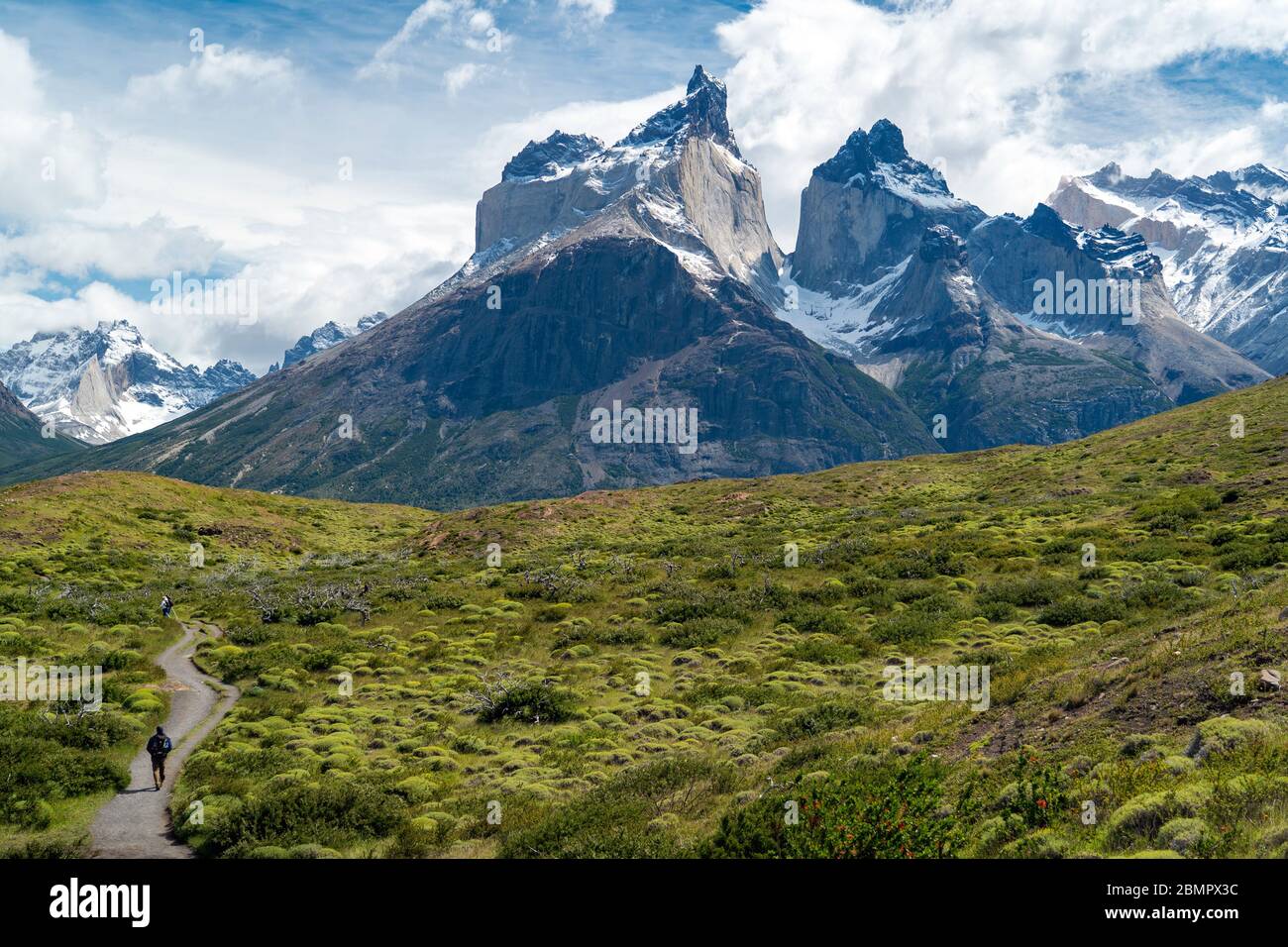 Hiker in Torres del Paine National Park in Chile with the iconic Cuernos del Paine mountains in the background, Patagonia, South America. Stock Photo