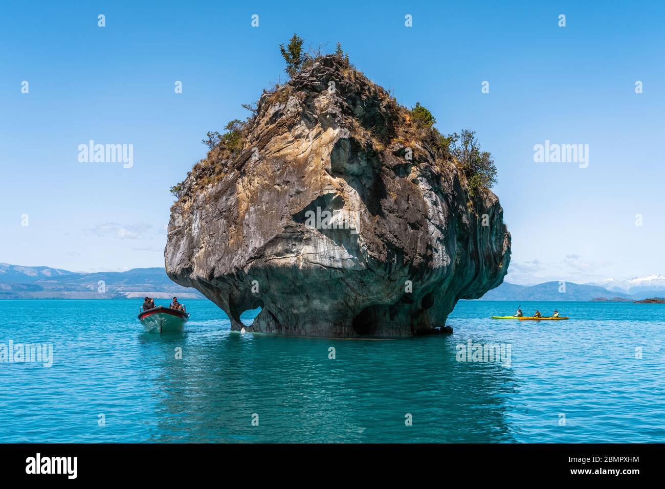 Tourists exploring the Marble Caves, a series of naturally sculpted caves and rock formations on General Carrera Lake in Patagonia, Chile. Stock Photo