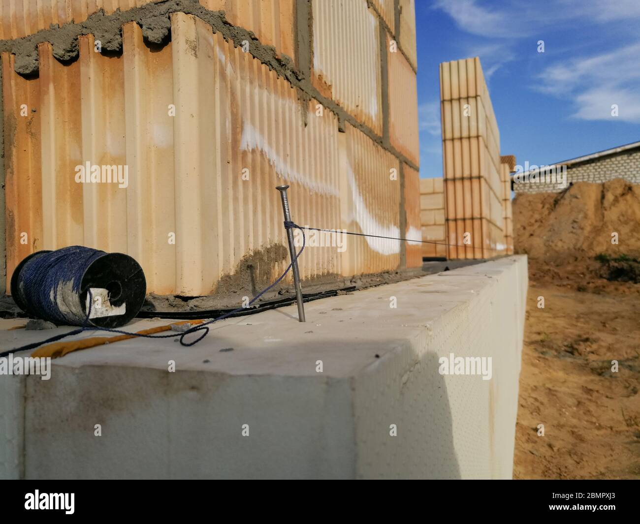 Nail and string for ceramic building block construction leveling in ...