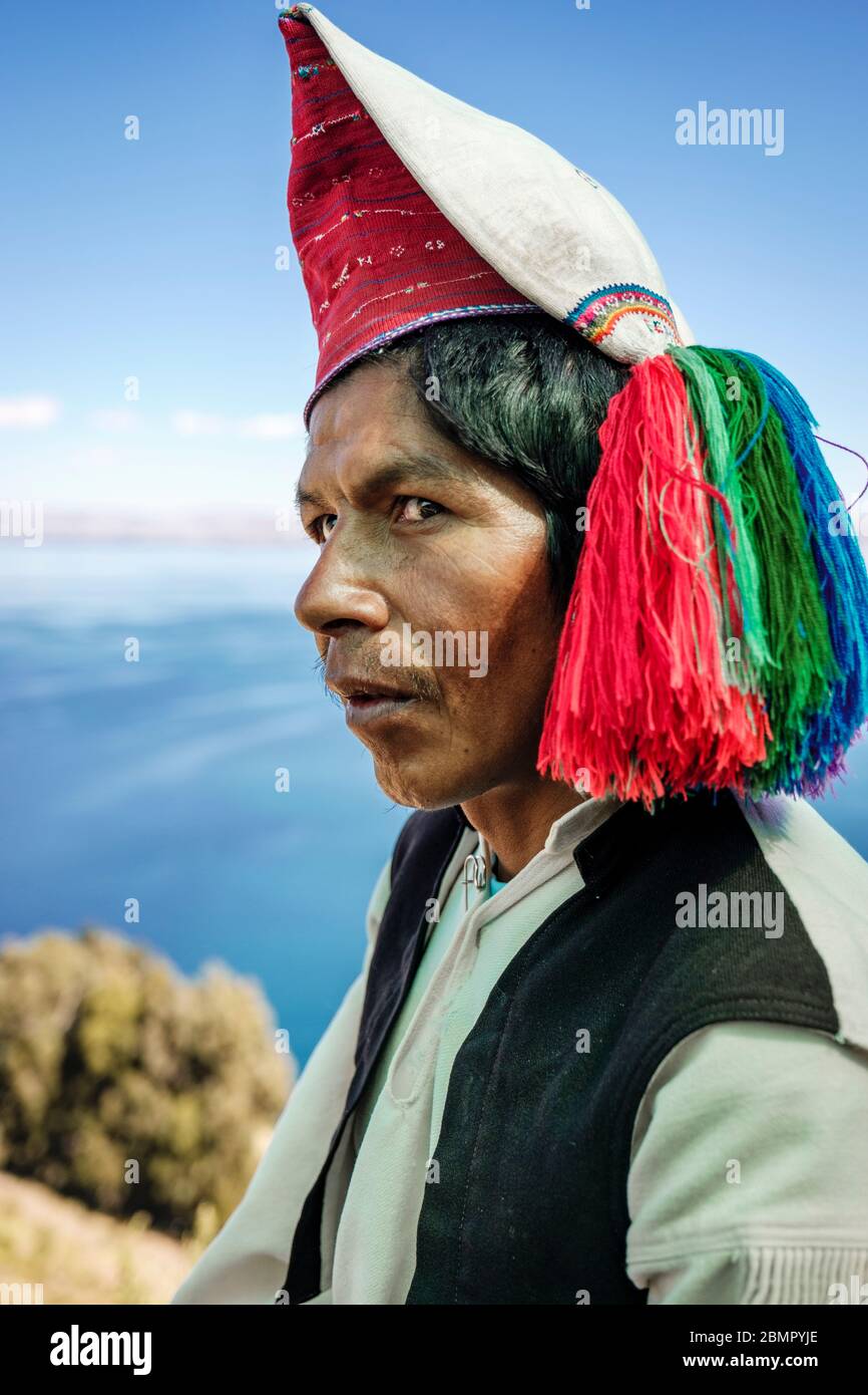 Headshot portrait of Isla Taquile married Quechua indigenous man wearing a traditional weaved hat, Taquile Island, Lake Titicaca, Peru Stock Photo