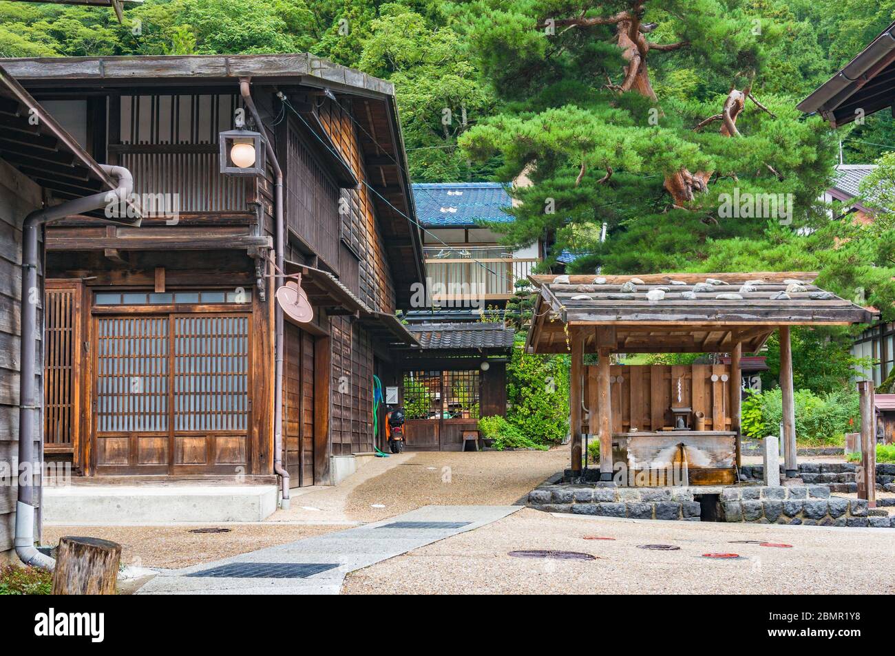 Traditional Japanese wooden houses and water well. Narai countryside