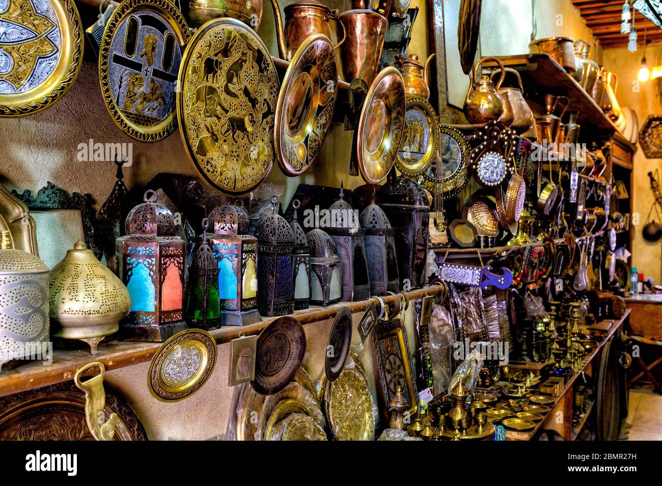 Antique brassware and decorative copper, bronze and iron plates, lanterns and pots on show at the Three Crazy Brothers store in Khan El Khalili market Stock Photo